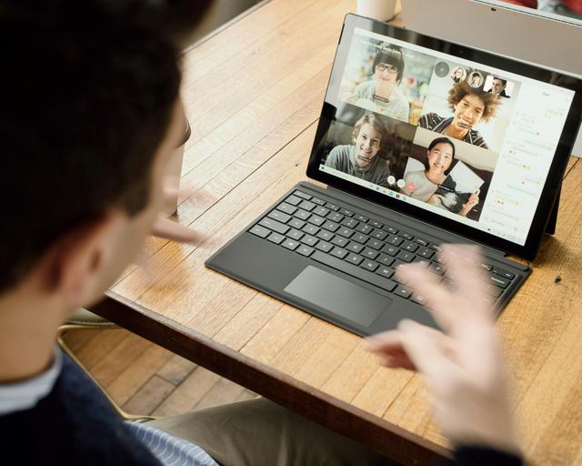 Man on video call with team